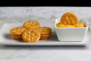 everything  crackers stacked  with cheese dip