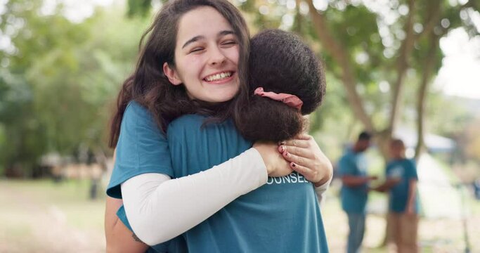 Women, hugging and volunteer support in nature together for trust or care. Summer, support and happy young female friends embracing while bonding at a campsite in the forest, woods or wilderness
