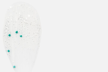 Smear, clear gel with blue granules, serum clear on a white background