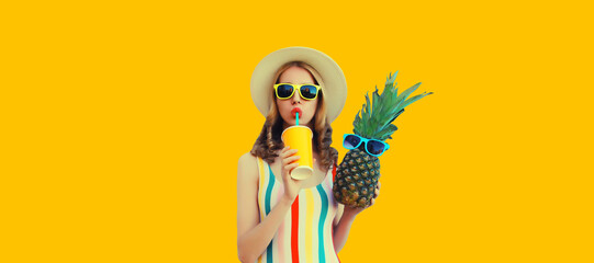 Summer portrait of stylish happy young woman drinks fresh juice with pineapple fruits wearing...