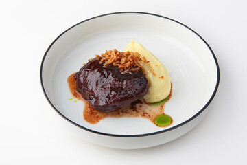 Beef cheeks with mashed potatoes. Meat menu in the restaurant. Hearty food. Meat food. Photo on a white background for the menu. Flat lay. Space for copying. Isolated object.