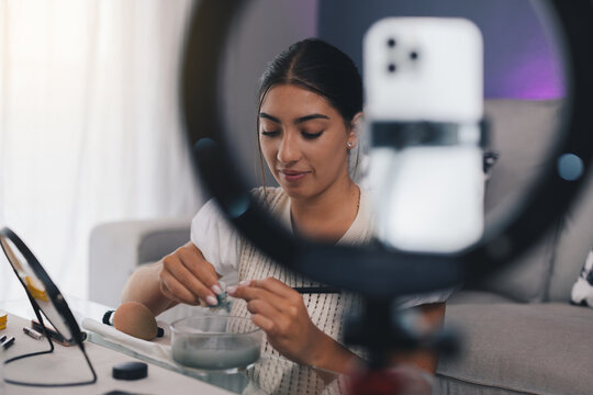 Hispanic blogger making natural skincare product at home while recording video