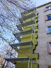 Thermal insulation of the facade of a apartment building with thick rock mineral wool plates