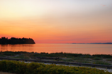 Orange and pink sunset in the Pacific ocean coast in summer.
