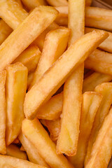 Delicious crispy french fries with salt and spices in a cardboard box