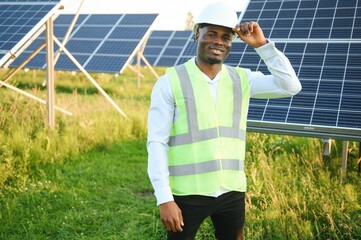 Photovoltaic Green Energy Technology. Worker At Solar Panel Plant