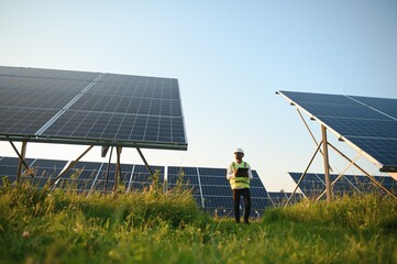 Photovoltaic Green Energy Technology. Worker At Solar Panel Plant