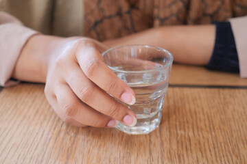 women holding a glass of water 