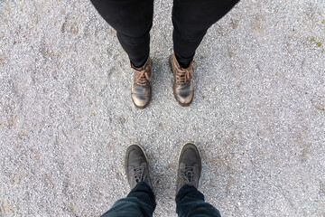 The couple stands opposite each other. Point of view.