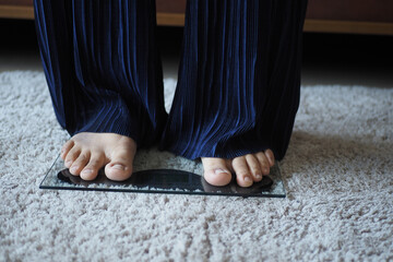 woman's feet on weight scale close up.