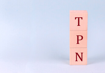 TPN - Total Parenteral Nutrition on wooden cubes on a blue background