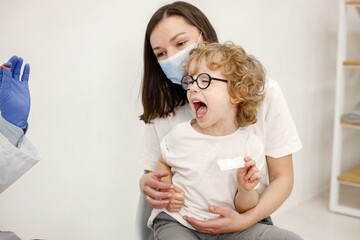 Little boy screaming because doctor is going to do vaccination