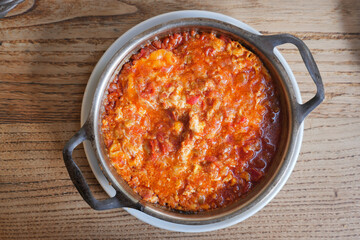 Turkish Menemen omelet in a frying pan. .