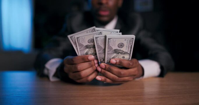 Close up shot selective focua African American brilliant mathematician or codebreaker, using the dollars as a cryptic message or puzzle to solve, leading him to a hidden secret or treasure.