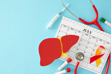 July 28th is World Hepatitis Day for better liver health. Top view of liver symbol, calendar, awareness ribbon, stethoscope,  blood sample, syringe on light blue background with empty space for text - obrazy, fototapety, plakaty