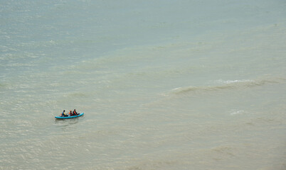 Obraz premium Unrecognized people canoeing in the sea in the morning. People exercising in the ocean