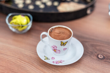 Yummy Turkish coffee served with chocolates  on a wooden table, close up