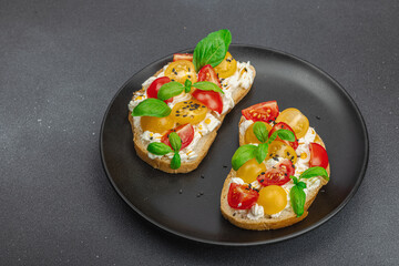 Fresh bread sandwiches with tomato cherry, cream cheese and basil leaves. Morning breakfast concept