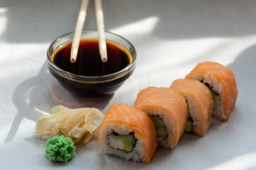 Rolls with salmon, wasabi, ginger and soy sauce