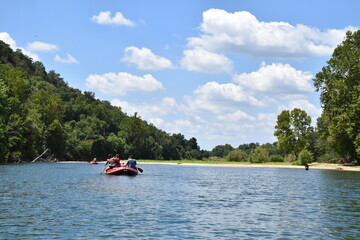 Fototapeta na wymiar People in a Raft on a River
