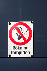 Smoking prohibited sign on a grey wall.