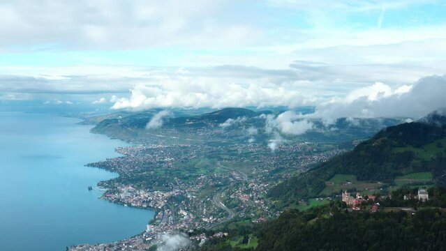 Aerial flight over Swiss Mountains with view of the Montreux City. View to Geneva Lake