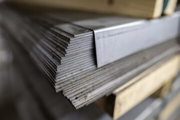 a stack of galvanized thick hot rolled steel sheets in a warehouse - 622439602