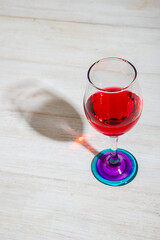 colorfull glass of wine with game of hard light and shadows
