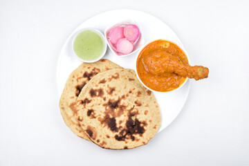 Top view of butter chicken with tandoori chapati in plate isolated on white background