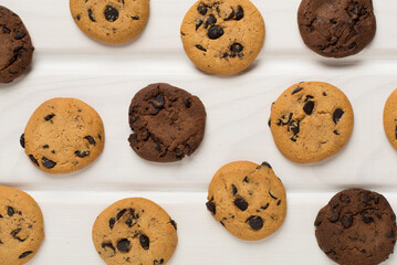 Flat lay with chocolate chip cookies on wooden background