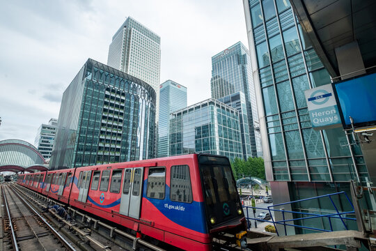 London- : View of Canary Wharf office towers and Docklands Light Railway train from Heron Quays DLR train station- Major London financial centre