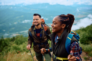 Happy nature lovers enjoying while hiking in mountains.