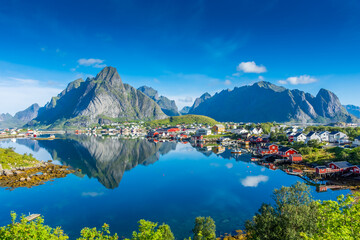 Fototapeta na wymiar Perfect reflection of the Reine village on the water of the fjord in the Lofoten Islands, Norway