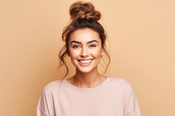 Obraz premium Cheerful and happy young woman with a bun and a bright smile, looking at the camera on studio shot. Generative AI