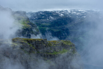 Moody foggy landscape in the mountains of Trolltunga,  Norway