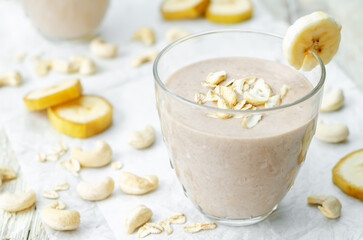 Cashews banana oat flakes smoothie in a glass