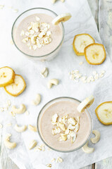 Cashews banana oat flakes smoothie in a glass