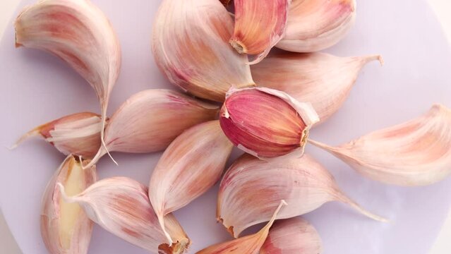 garlic, rotation in circle. Turning garlic cloves. selective focus.