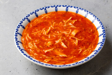 Chicken noodle soup with tomato. Turkish name; Domatesli tavuklu sehriye corbasi