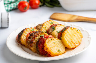 Traditional Turkish food; baked potatoes and meatballs. Turkish name; kofteli patates dizmesi, patates dizme
