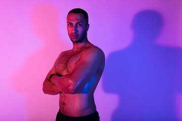 Muscular African American Sporty Guy Posing Shirtless Over Purple Background