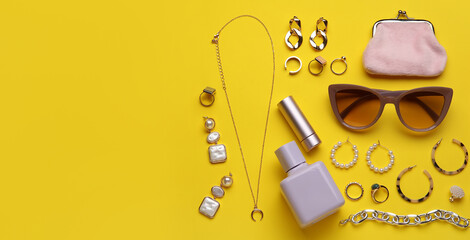 Set of stylish female accessories on yellow background with space for text