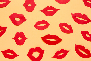 Red paper lips on color background