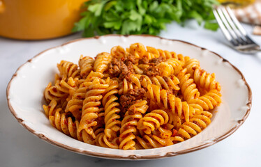 Fusilli pasta, spiral or spirali pasta with tomato, minced  sauce - Italian food style