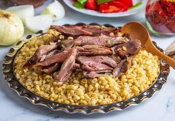 Turkish foods; lamb shank tandoori on bulgur wheat rice (Turkish name; bulgur bugday pilavi kuzu incik tandir, kuzu tandir)