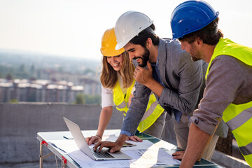 Team of architects people in group on construciton site check documents and business workflow