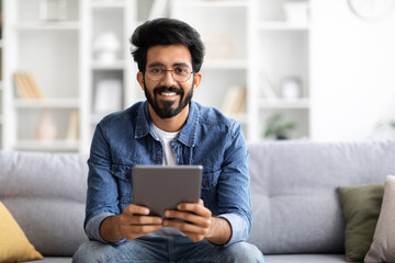 Handsome Indian Guy Holding Digital Tablet Computer And Smiling At Camera