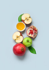 Composition with ripe fruits and bowl of honey on light background. Rosh hashanah (Jewish New Year) celebration