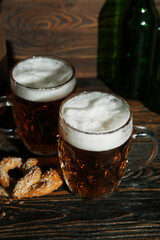 Mugs of cold beer on wooden background. Oktoberfest celebration