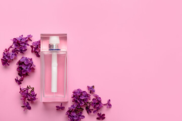Beautiful lilac flowers and bottle of perfume on pink background